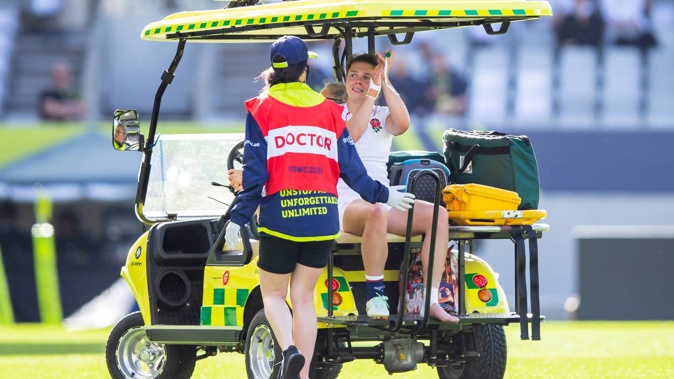 England's Helena Rowland waves to fans while being carted off the field against Canada. Photo / Photosport