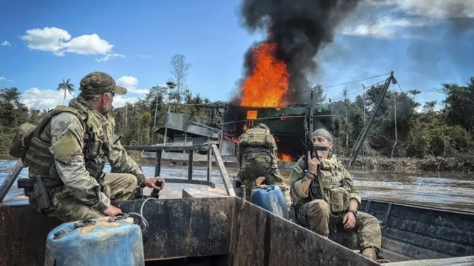 Federal agents destroy an illegal mining barge inside Yanomami Indigenous territory. Photo / IBAMA via AP