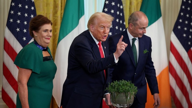 US President Donald Trump meets with Irish Taoiseach Micheál Martin and his wife Mary O'Shea during a St Patrick's Day event in the East Room of the White House on March 12. Photo / AFP