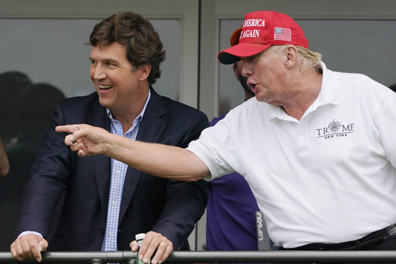 Tucker Carlson, left, and former President Donald Trump, talk while watching golfers on the 16th tee during the final round of the LIV Golf Invitational at Trump National in Bedminster, N.J. Photo / AP