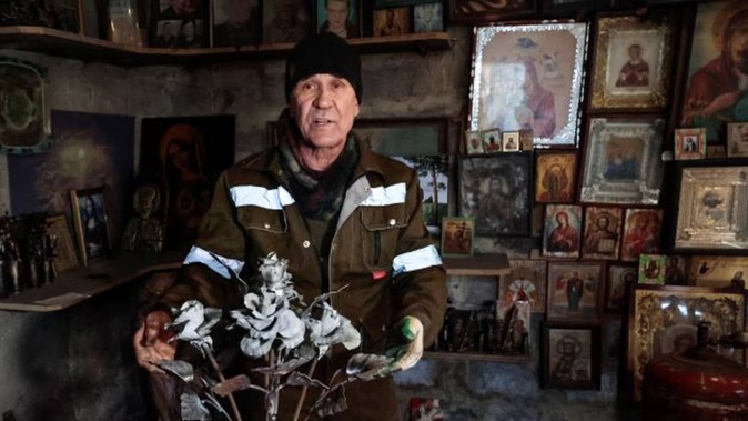 Viktor Mikhalev shows roses transformed from weapons and ammunition into flowers of war standing in a workshop in his house in Donetsk, in the Russian-controlled Donetsk region of eastern Ukraine. Photo / AP