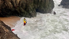 Waipu Cove surf lifeguard Rick Stolwerk helps to rescue the family stuck inside a cave between Ding Bay and Langs Beach.