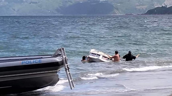 The group managed to pull the boat to shore with the child trapped underneath. Photo / Supplied
