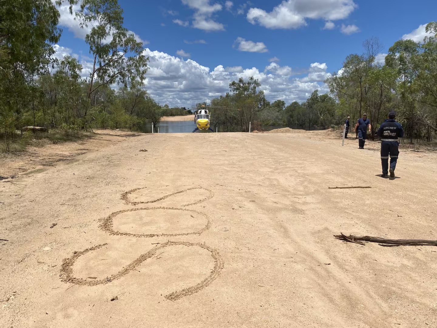 An 'SOS' sign a couple wrote in the dirt in the Gulf Country in North West Queensland, Australia, after getting stranded when their 4WD was swept away by flood waters. Photo / LifeFlight