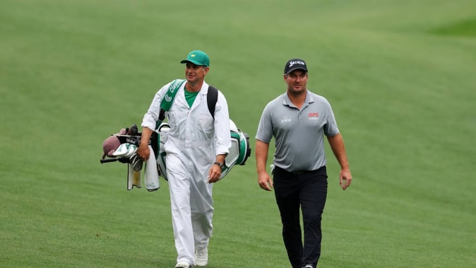 Ryan Fox walks up the 13th fairway with his caddie, Dean Smith, during a practice round prior to the 2023 Masters. Photo / Getty