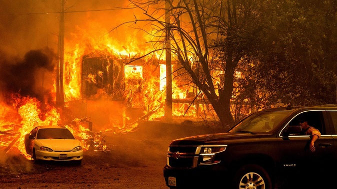 Flames from the Dixie Fire consume a home on Highway 89 south of Greenville on August 5, 2021, in Plumas County, California. (Photo / AP)
