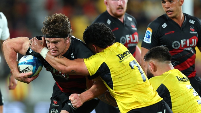 Scott Barrett of the Crusaders is tackled during the round nine Super Rugby Pacific match between Hurricanes and Crusaders at Sky Stadium, on April 11, 2025, in Wellington, New Zealand. (Photo by Hagen Hopkins/Getty Images)