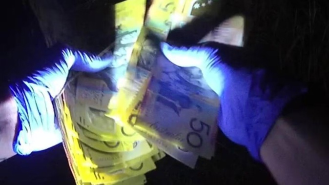 Tens of thousands of dollars in cash has been found on a Perth freeway. Photo / WA Police