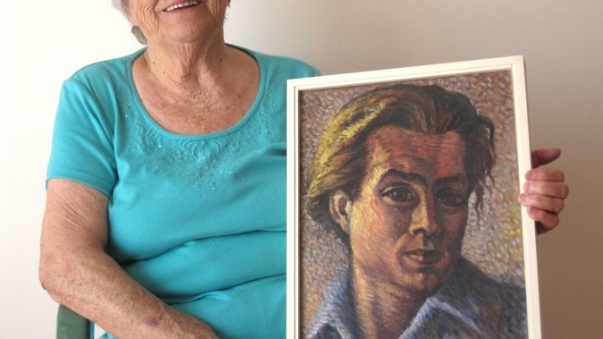 Dora Bakkenes holding a self-portrait of her late-husband Walter Bakkenes in 2014. Photo / Supplied