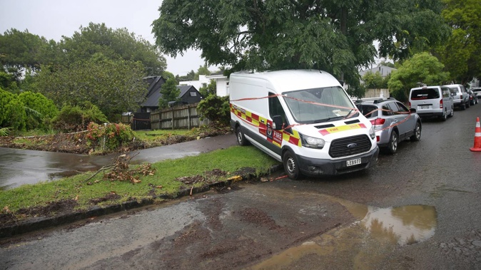 Residents of Dryden St in Grey Lynn clean up in the aftermath of the storms and flooding over the weekend. Photo / Alex Burton