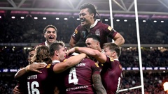 Queensland players celebrate one of six tries scored during their State of Origin victory over NSW in Brisbane. Photo / Getty