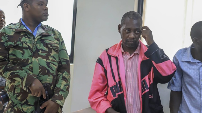 Preacher Paul Mackenzie, centre, who was arrested two weeks ago for asking his followers to starve to death in order to meet Jesus, appears at a court in Malindi, Kenya Tuesday on May 2. Photo / AP