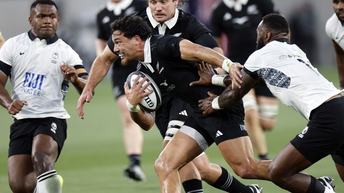 Billy Proctor #13 of New Zealand All Blacks breaks a tackle by Semi Radradra #11 of Fiji during the first half of International Test between New Zealand All Blacks and Fiji at Snapdragon Stadium on July 19, 2024 in San Diego, California. (Photo by Kevork Djansezian/Getty Images)