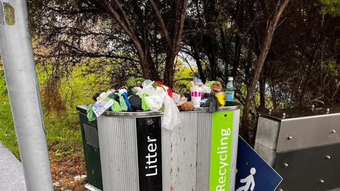 This overflowing bin at Hobsonville was blamed on the removal of another. Photo / David Baker