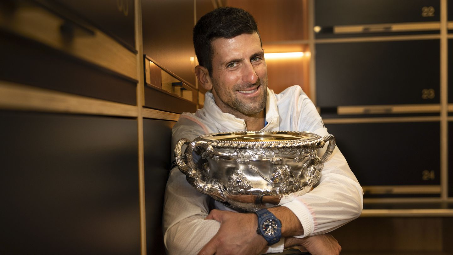Novak Djokovic hugs the Norman Brookes Challenge Cup in the locker-room after taking out the men's 2023 Australian Open title. Photo / AP