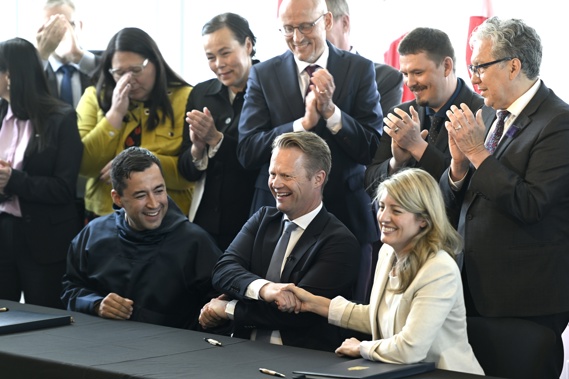 Greenland Prime Minister Mute Bourup Egede, left, Denmark's Minister for Foreign Affairs Jeppe Kofod, center, and Canada's Minister of Foreign Affairs Melanie Joly share a three-way handshake after signing an agreement that will establish a land border between Canada and Denmark on Hans Island. Photo / AP