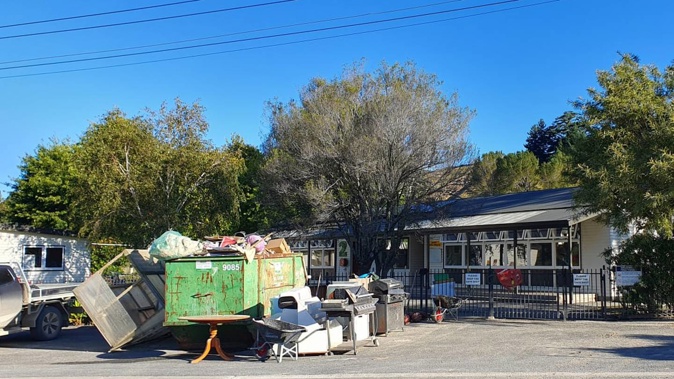 Rubbish outside Tīnui School after firefighters hosed silt from classes and the field. Photo / RNZ