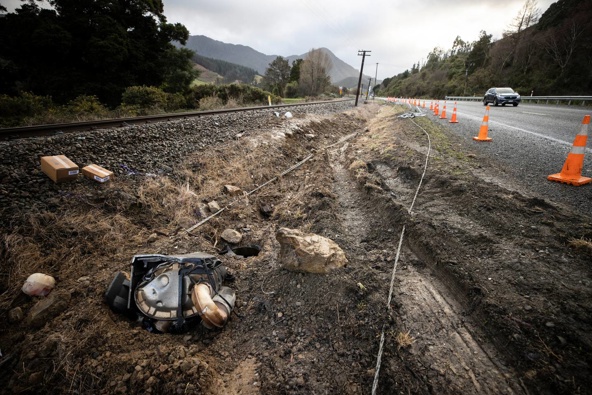 Crash debris litters the road on Monday where seven people died after a van crashed into a truck south of Picton on Sunday. Photo / George Heard