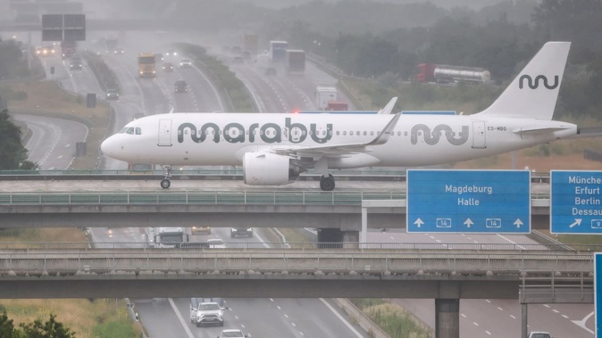 An Airbus A320neo from Estonian airline Marabu crosses a bridge over the highway at Germany's Leipzig-Halle Airport on June 27. Photo / Jan Woitas, dpa Picture-Alliance via AFP