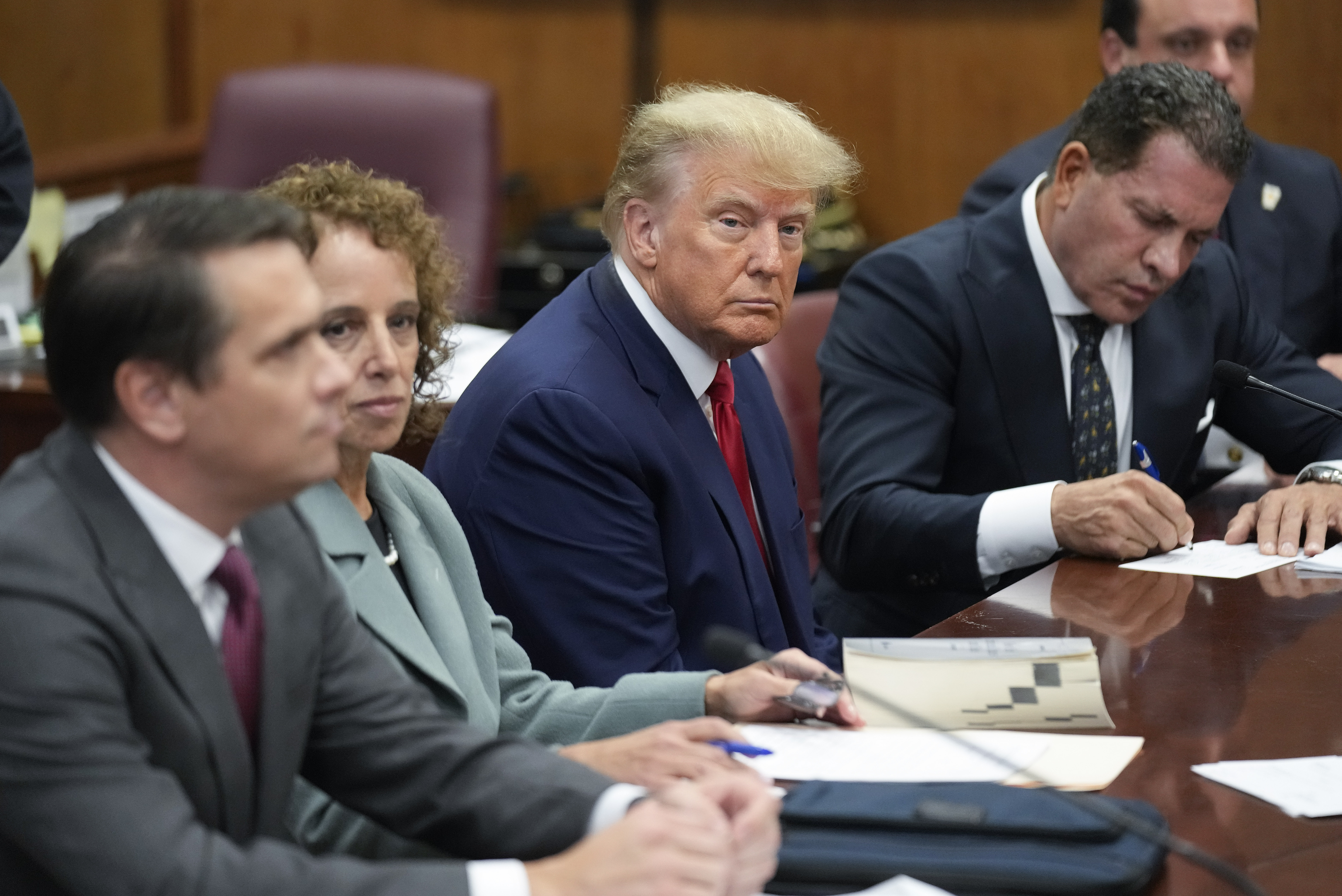 Former President Donald Trump sits at the defense table with his legal team in a Manhattan court, Tuesday, April 4, 2023, in New York. Trump appeared in court on charges related to falsifying business records in a hush money investigation, the first president ever to be charged with a crime. Photo / AP