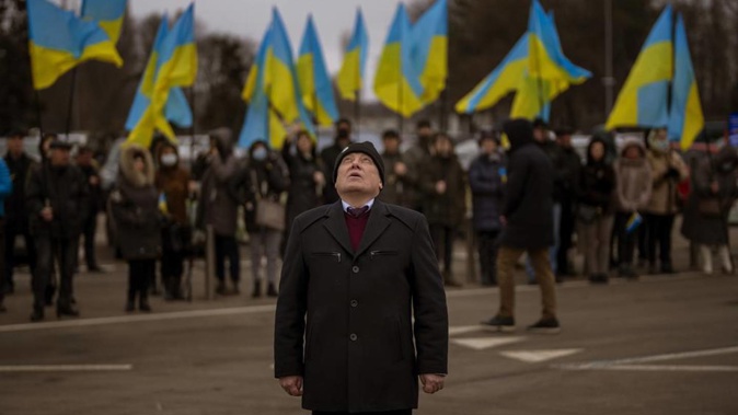 People hold Ukrainian flags as they gather to celebrate a Day of Unity in Odessa. Photo / AP