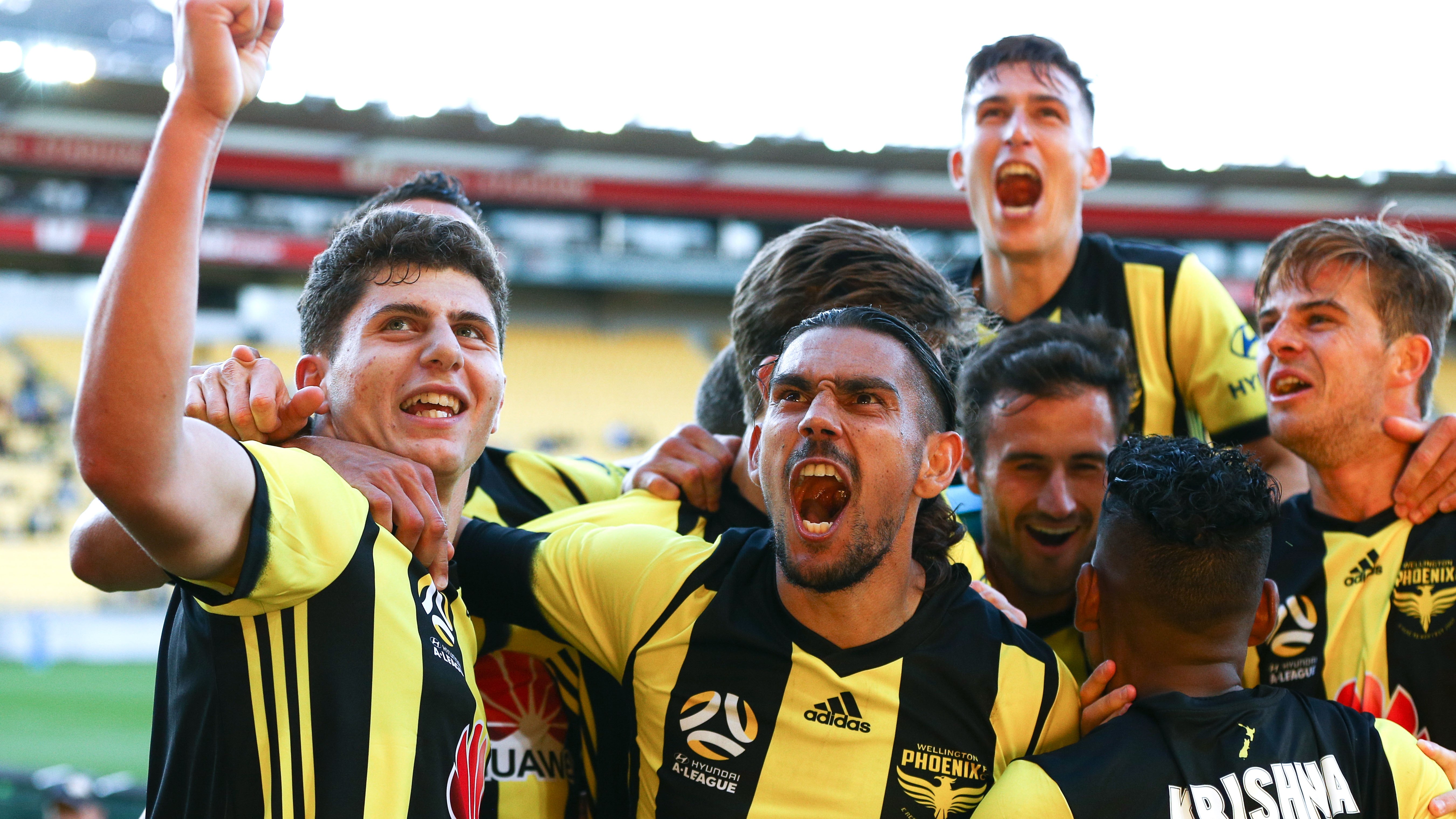 David Williams and Liberato Cacace of the Phoenix celebrate the goal of Roy Krishna during the round one A-League match between the Wellington Phoenix and the Newcastle Jets at Westpac Stadium on October 21, 2018 in Wellington, New Zealand. (Photo by Hagen Hopkins/Getty Images)