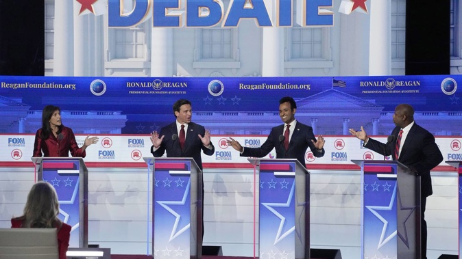 From left to right, former UN Ambassador Nikki Haley, Florida Governor Ron DeSantis, businessman Vivek Ramaswamy and Senator Tim Scott argue during the debate. Photo / AP