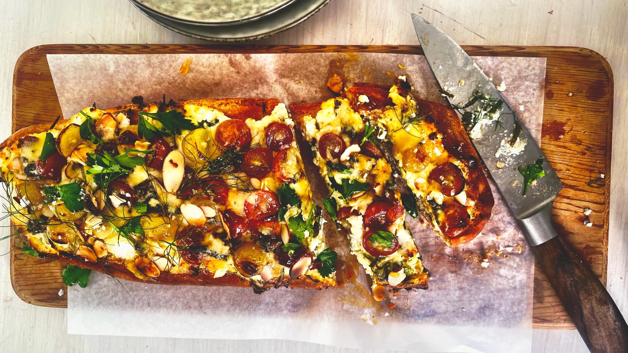 The cheesy herb and grape variant of Nici's BBQ pizza. Photo / Supplied