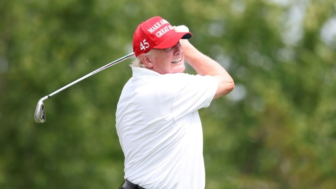 Former US President Donald Trump plays a shot during the pro-am at the Bedminister LIV Golf Invitational in July last year. Photo / Getty
