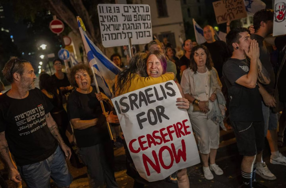 An Israeli woman calling for a ceasefire in the Gaza Strip is comforted by another protester after an argument with a right-wing Israeli in Tel Aviv. Photo / AP