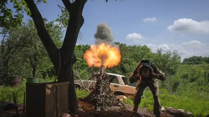A Ukrainian soldier fires a mortar at Russian positions on the frontline near Bakhmut, Donetsk region, Ukraine. Photo / AP