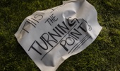 A sign that reads "This Is The Turning Point" lies next to a memorial for political activist Charlie Kirk on the grounds of Utah Valley University. Photo / Getty Images