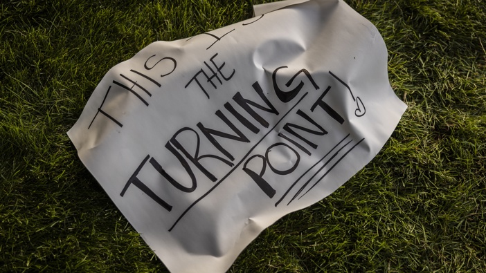 A sign that reads "This Is The Turning Point" lies next to a memorial for political activist Charlie Kirk on the grounds of Utah Valley University. Photo / Getty Images