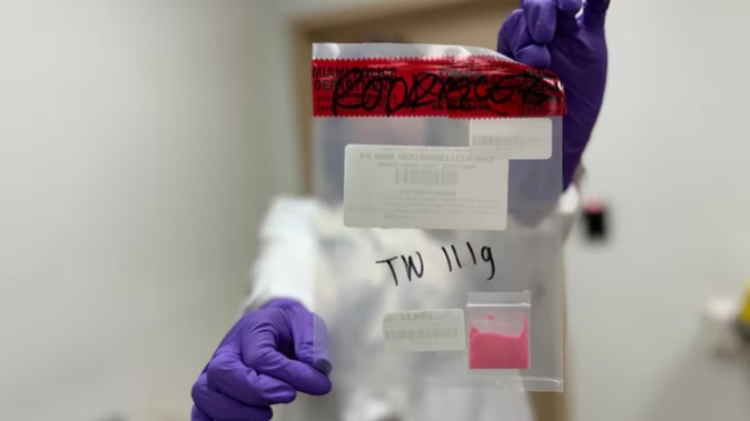 Diane Moore, head of toxicology for the Miami-Dade County Medical Examiner's Office, holds a sample of suspected tusi. Photo / David Ovalle/The Washington Post