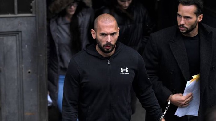 Andrew Tate, centre, and his brother Tristan, leave after appearing at the Court of Appeal, in Bucharest, Romania. Photo / AP