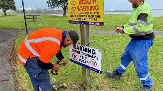 Workers post a health warning sign at Ngamotu Beach in New Plymouth in November 2020. Photo / Supplied