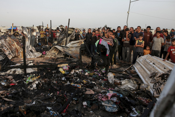 FILE - Palestinians look at the destruction after an Israeli strike where displaced people were staying in Rafah, Gaza Strip, Monday, May 27, 2024. Throughout its grinding seven-month war against Hamas, Israel has pledged to investigate a series of deadly events in which its military forces are suspected of wrongdoing. (AP Photo/Jehad Alshrafi, File)