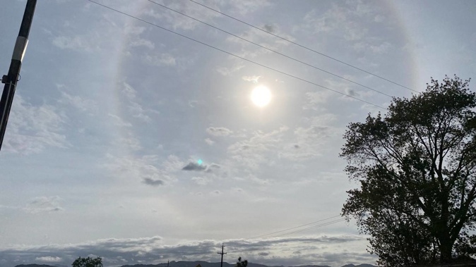 The phenomenon is caused the refraction of light (in this case, sunlight) through ice crystals, and is known as a 22° halo. Photo / Jim Birchall