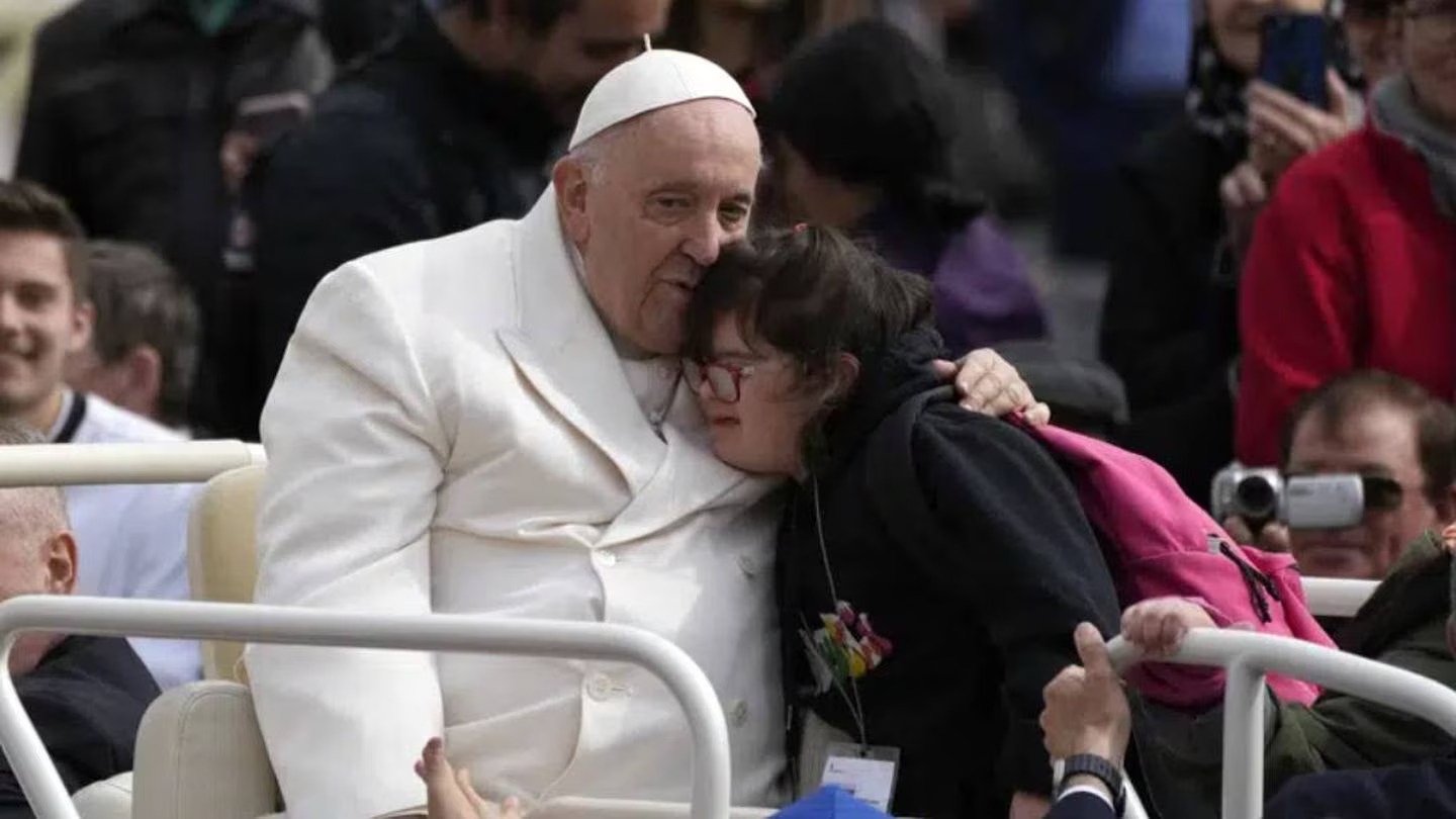 Pope Francis hugs a child at the end of his weekly general audience in St Peter's Square, at the Vatican. Photo / AP
