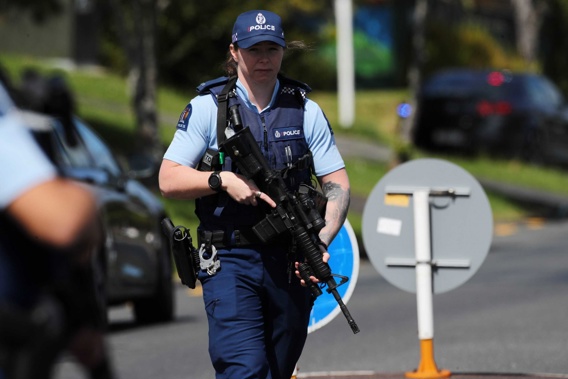 Armed police patrol Hutchinson Ave in New Lynn. Photo / Hayden Woodward