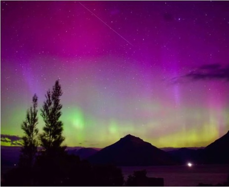 The southern lights light up the sky over Lake Wakatipu, from Jacks Point, on Monday night. Photo / Georgia Wallace