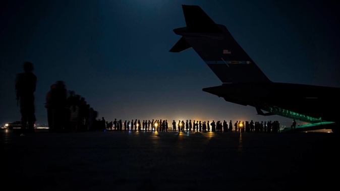 US Air Force aircrew preparing to load qualified Afghan evacuees aboard a US aircraft in August, 2021. Photo / Senior Airman Taylor Crul, via AP, Fuile