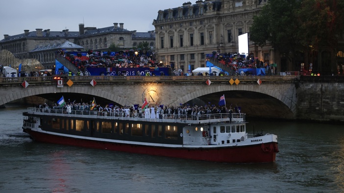 Team New Zealand, Team Oman, Team Uganda, Team Uzbekistan and Team Pakistan are seen on a boat passing beneath the Pont Au Change along the River Seine during the opening ceremony of the Olympic Games Paris 2024 on July 26, 2024 in Paris, France. (Photo by Buda Mendes/Getty Images)
