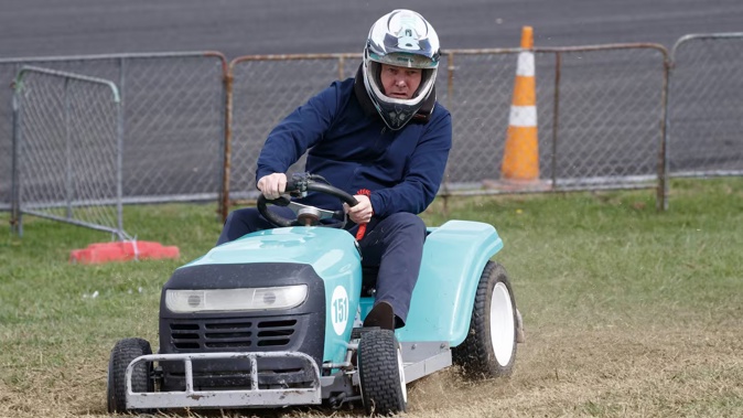 Prime Minister Christopher Luxon racing a ride-on lawnmower during his visit to the Central Districts Field Days at Manfeild on Thursday. Photo / Mark Mitchell