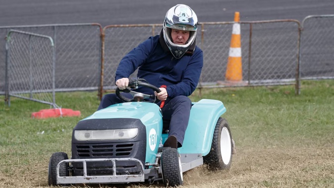 Prime Minister Christopher Luxon racing a ride-on lawnmower during his visit to the Central Districts Field Days at Manfeild on Thursday. Photo / Mark Mitchell