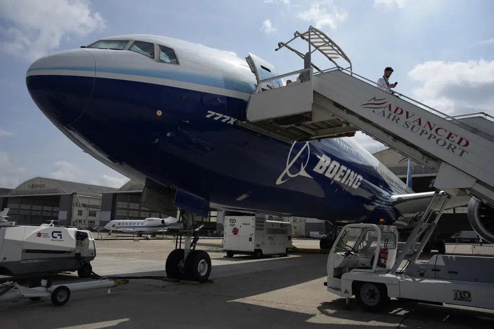  A man walks down the steps of the Boeing 777X airplane during the Paris Air Show in Le Bourget, north of Paris, France, Monday, June 19, 2023. Airlines are facing increasing pressure to cut their climate-changing emissions. That made sustainable aviation fuel a hot topic this week at the Paris Air Show, a major industry event. Sustainable fuel made from food waste or plant material is aviation's best hope for reducing emissions in the next couple of decades. (AP Photo/Lewis Joly, File)