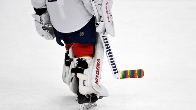 Florida Panthers goaltender Alex Lyon warms up while celebrating Pride Night with a colourful hockey stick. Photo / AP