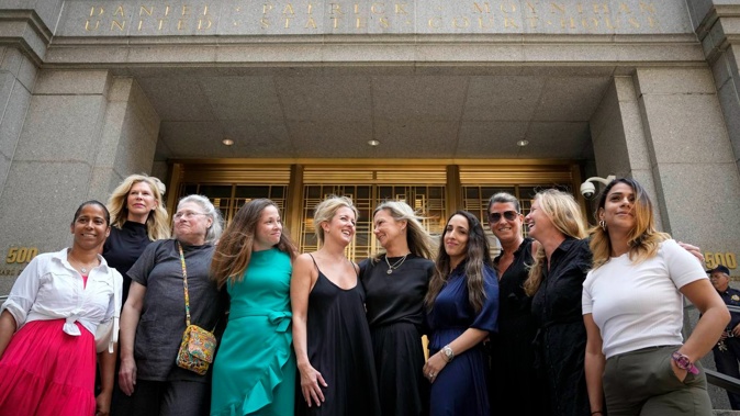 Sexual assault victims share smiles as they gather for a group photograph after sentencing proceedings concluded for convicted sex offender Robert Hadden. Photo / AP