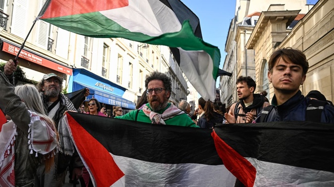 Protesters and relatives of the French nationals who took part in a flotilla march towards the Hotel Matignon, the French Prime Minister's official residence, in Paris on October 5. Photo / Julien De Rosa, AFP