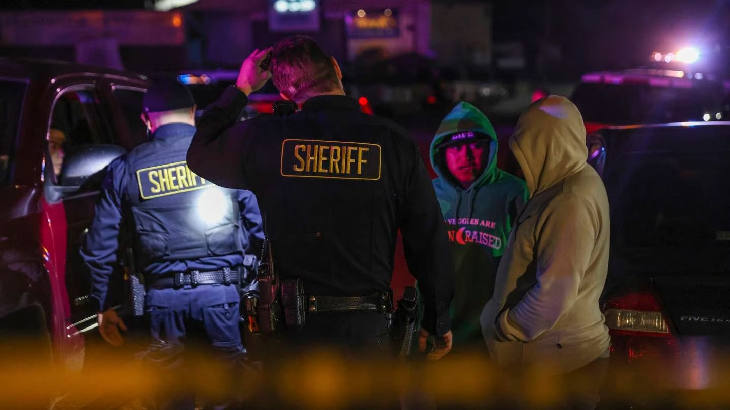 Sheriff's deputies talk with people at the scene of a deadly shooting in Half Moon Bay, California, last month. A major federal report into gun crime in the US has just been released. Photo / via AP